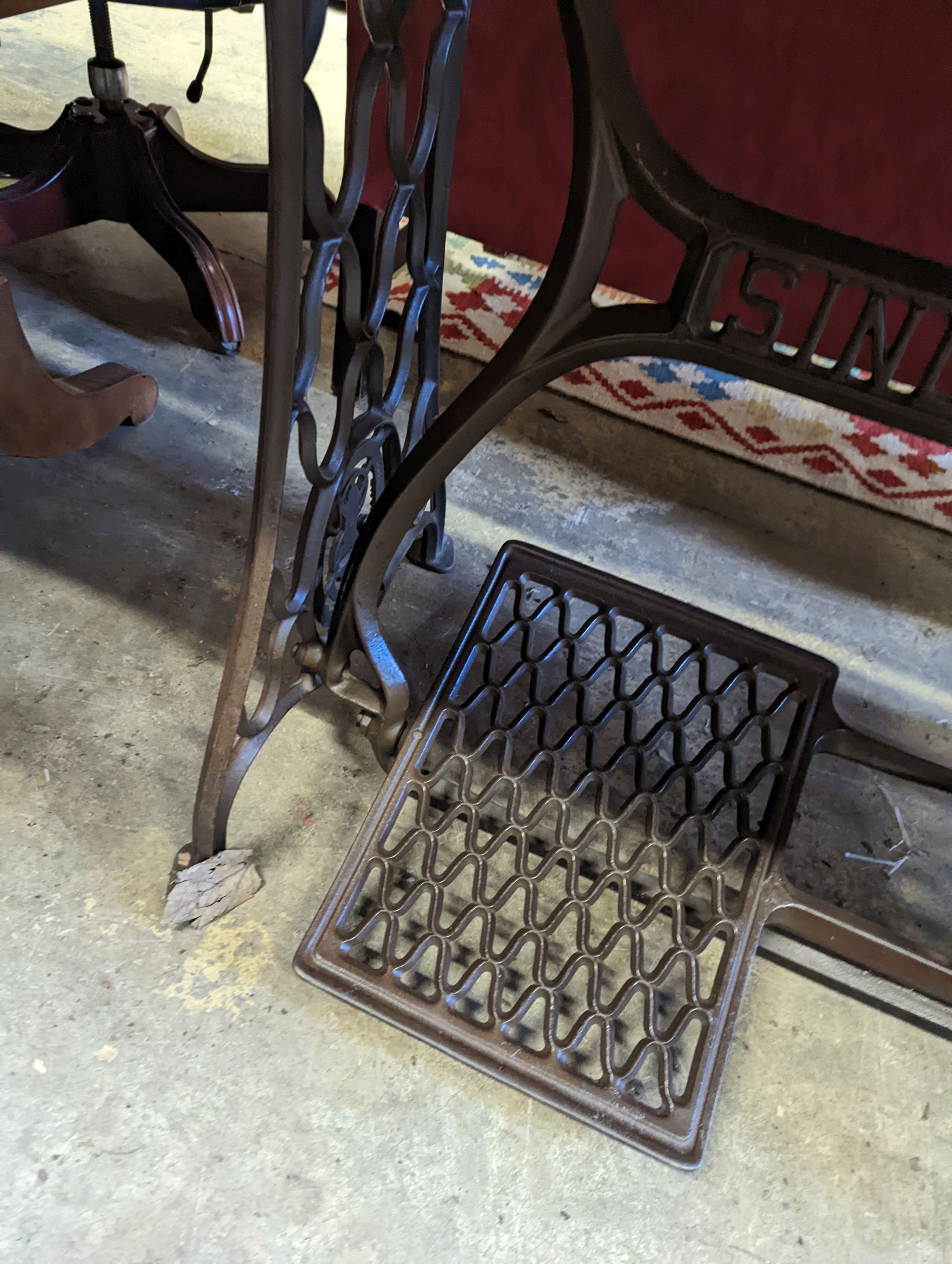 A Singer sewing machine treadle base with later marble top, width 130cm, depth 70cm, height 76cm